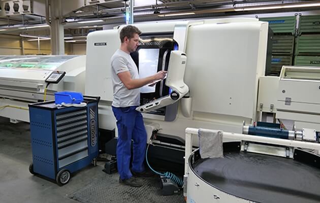 Mr. Hauser at a machine in production.