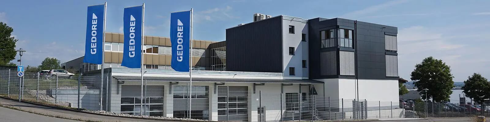 Gedore Automotive company building with flags in the foreground.